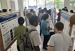 Participants discuss posters at the 2024 Tri-I Chemical Biology Symposium