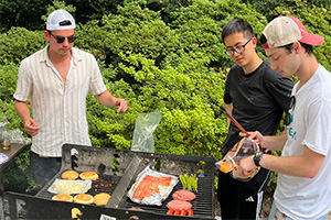 TPCB students Nico Carbone, Zirong Chen, and Colin Burdette oversee the barbeque.